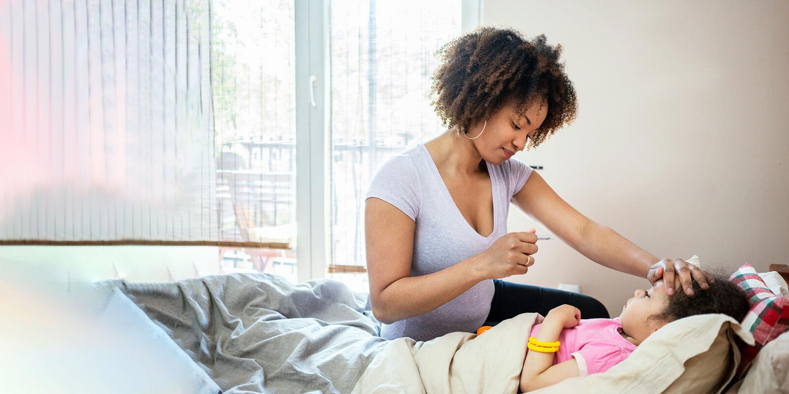 Mother taking care of her sick daughter