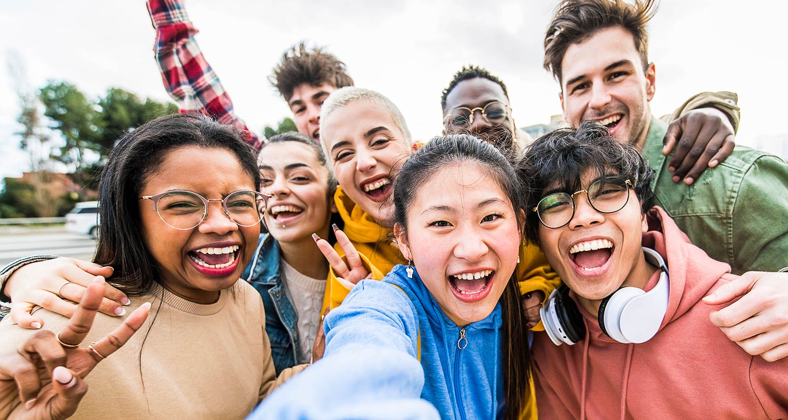 Laughing young people standing outdoors